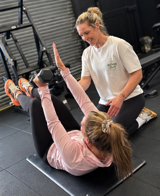 Lesley coaching a client in the gym