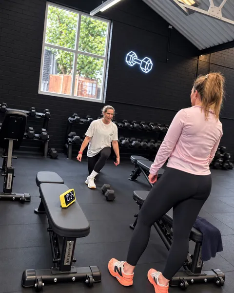Lesley coaching a client through a workout