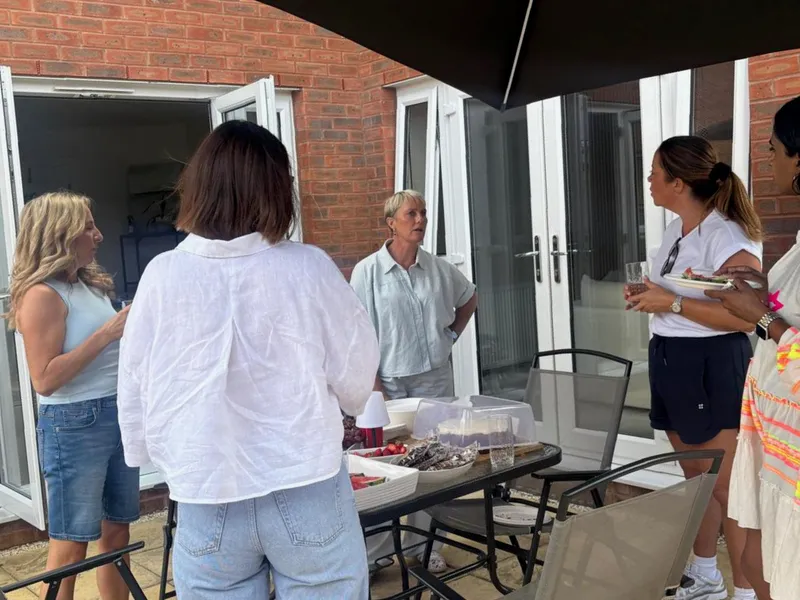 Lesley chatting with women on the patio